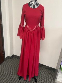 Handmade red dress with pearl detailing crafted by the Hope Boutique women