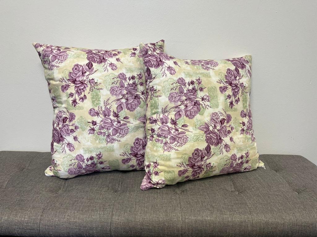 Pair of handmade floral throw pillows made by the Hope Boutique women