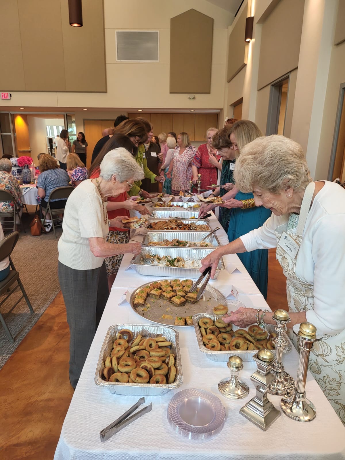 Guests serving themselves from a Hope Kitchen catering buffet at a community event